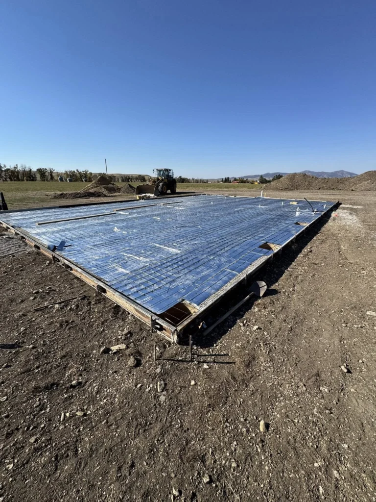Heated concrete garage pad with embedded hydronic or electric heating system