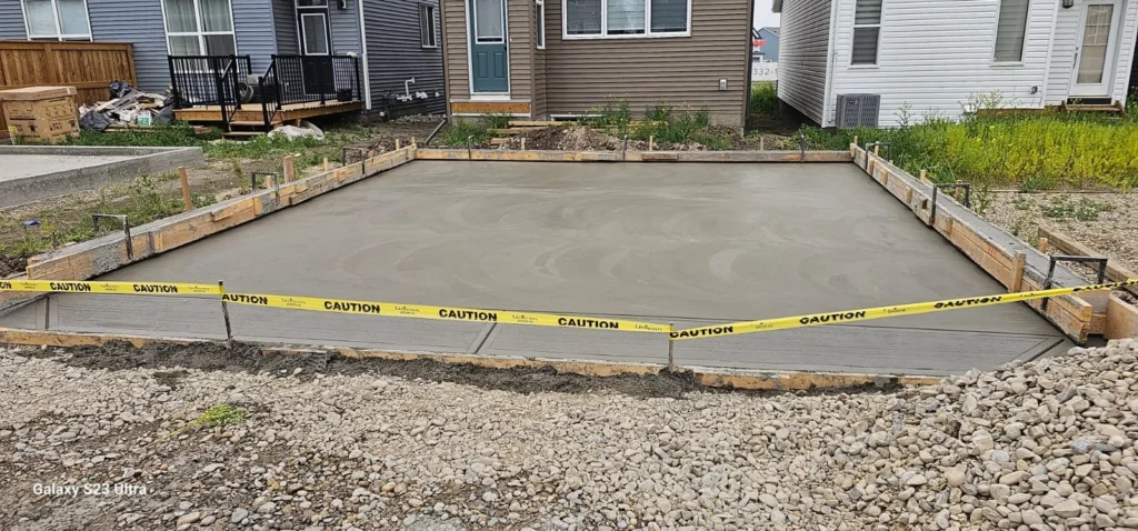 Reinforced concrete garage pad slab supporting a residential garage in Edmonton.