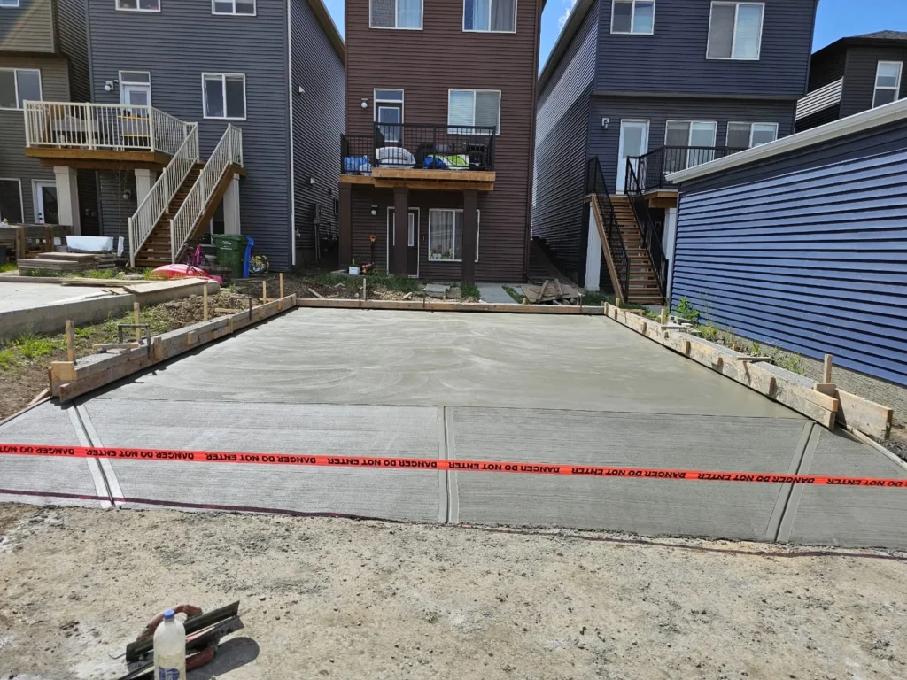 Concrete garage pad supporting cars and heavy equipment in Edmonton driveway