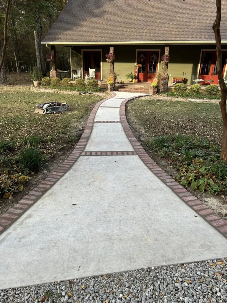Residential concrete walkway leading to home entrance, installed by concrete sidewalk & walkway services in Edmonton