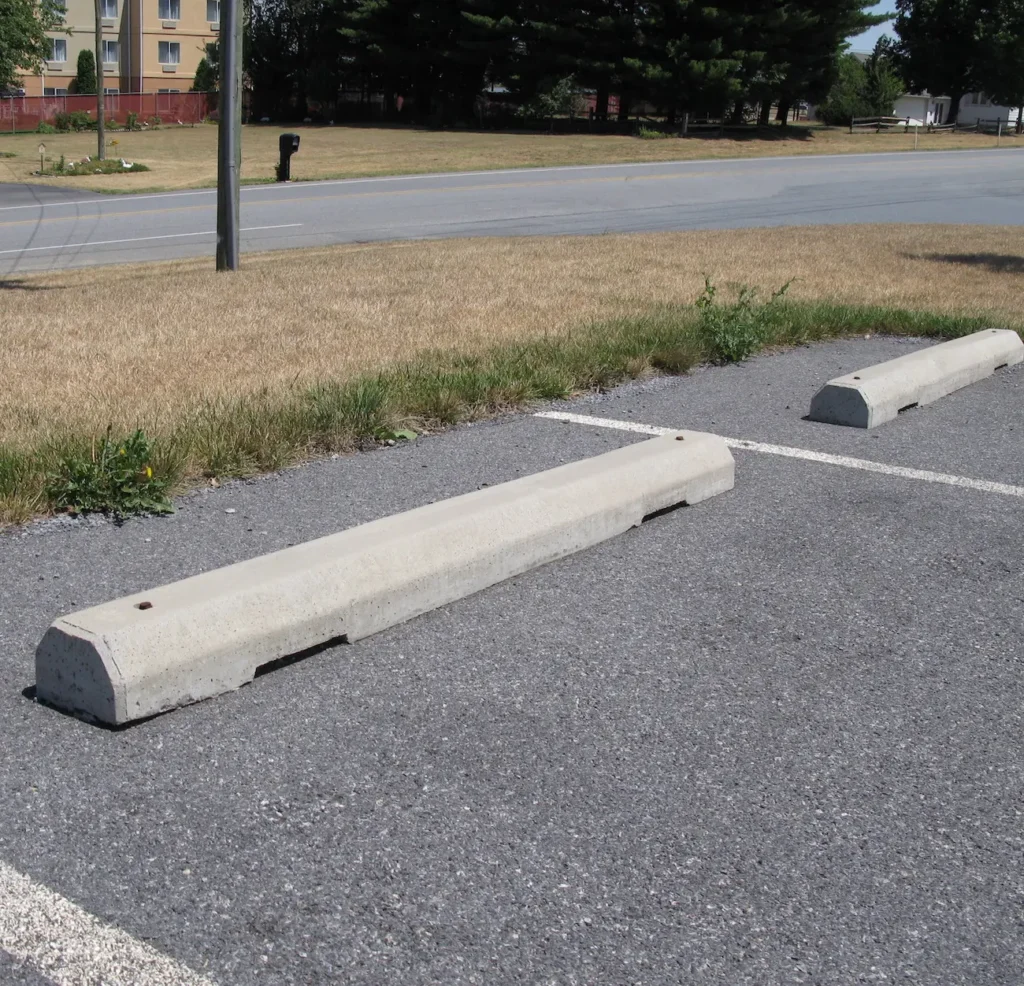 Concrete parking stops installed as part of parking lot concrete installation & repair in Edmonton to improve safety and traffic control.