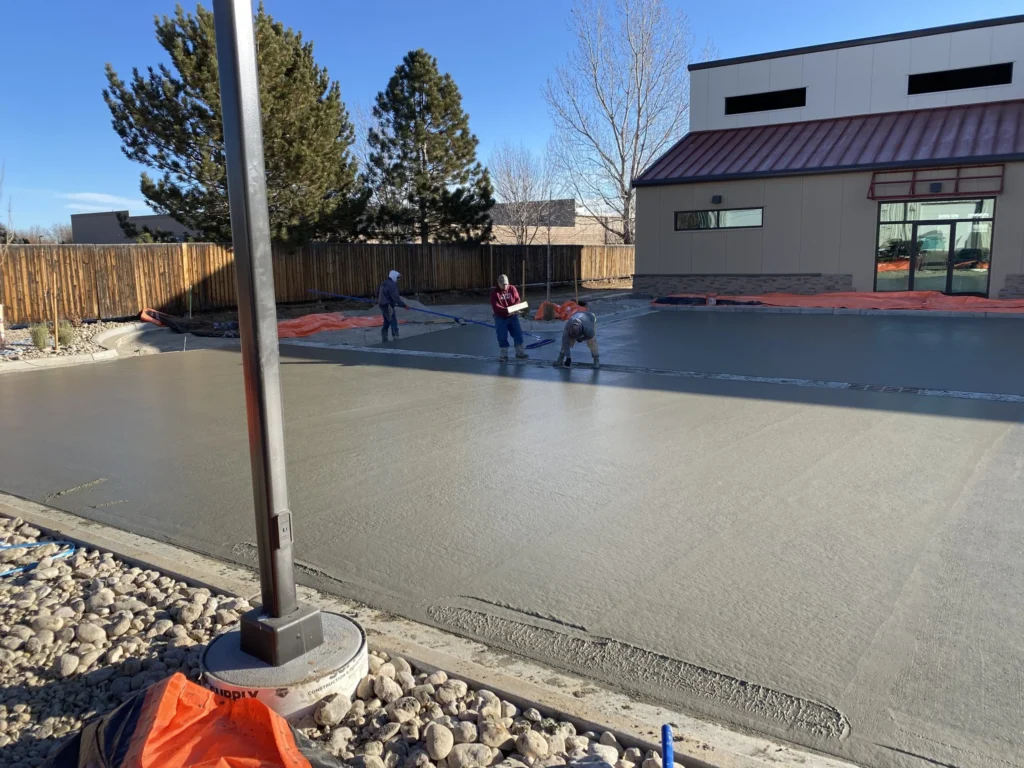 Parking lot concrete installation & repair in Edmonton showing professional crew finishing a commercial concrete parking lot for long-term durability.