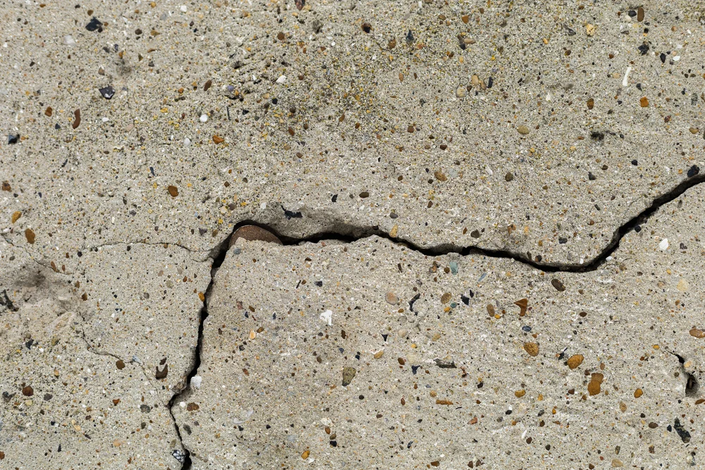 winter concrete damage prevention showing deep crack caused by freeze-thaw cycles
