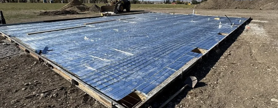 Heated concrete garage pad with embedded hydronic or electric heating system